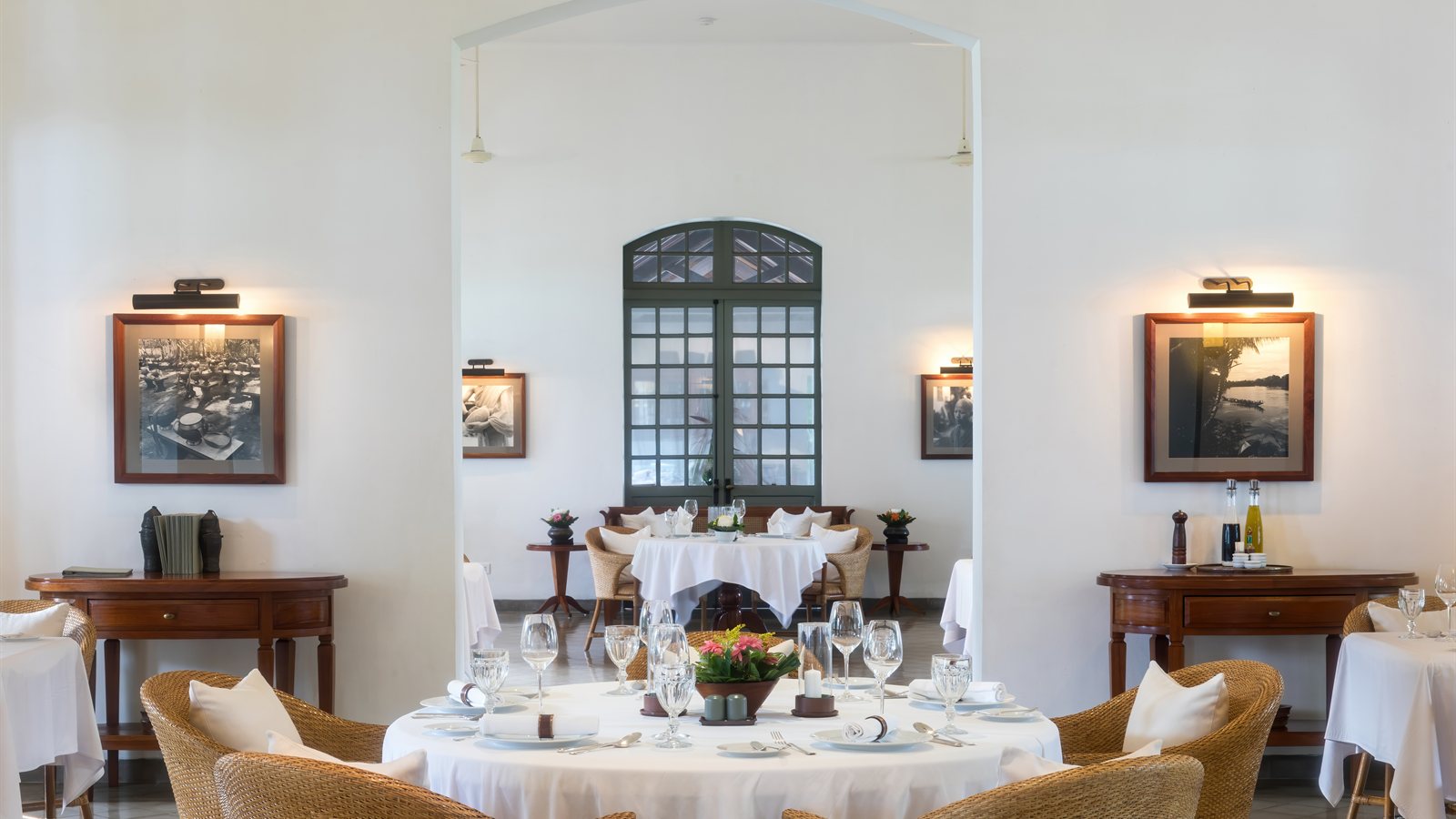 Table laid with linen and glassware in a bright dining room
